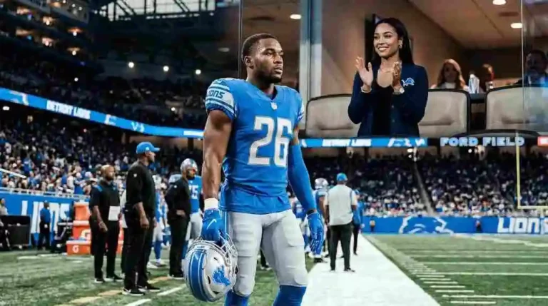 NFL running back Jahmyr Gibbs on the field with jahmyr gibbs girlfriend Nicole Anderson cheering from a luxury suite